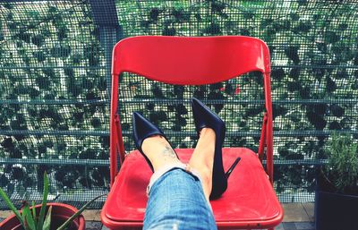 Low section of woman sitting on chair