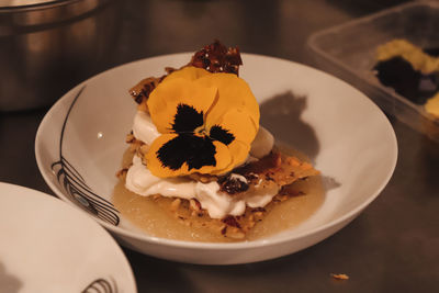 Close-up of cake slice in plate whit flower 