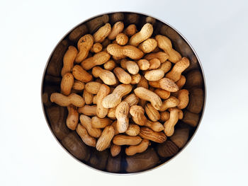 Close-up of bread in bowl against white background