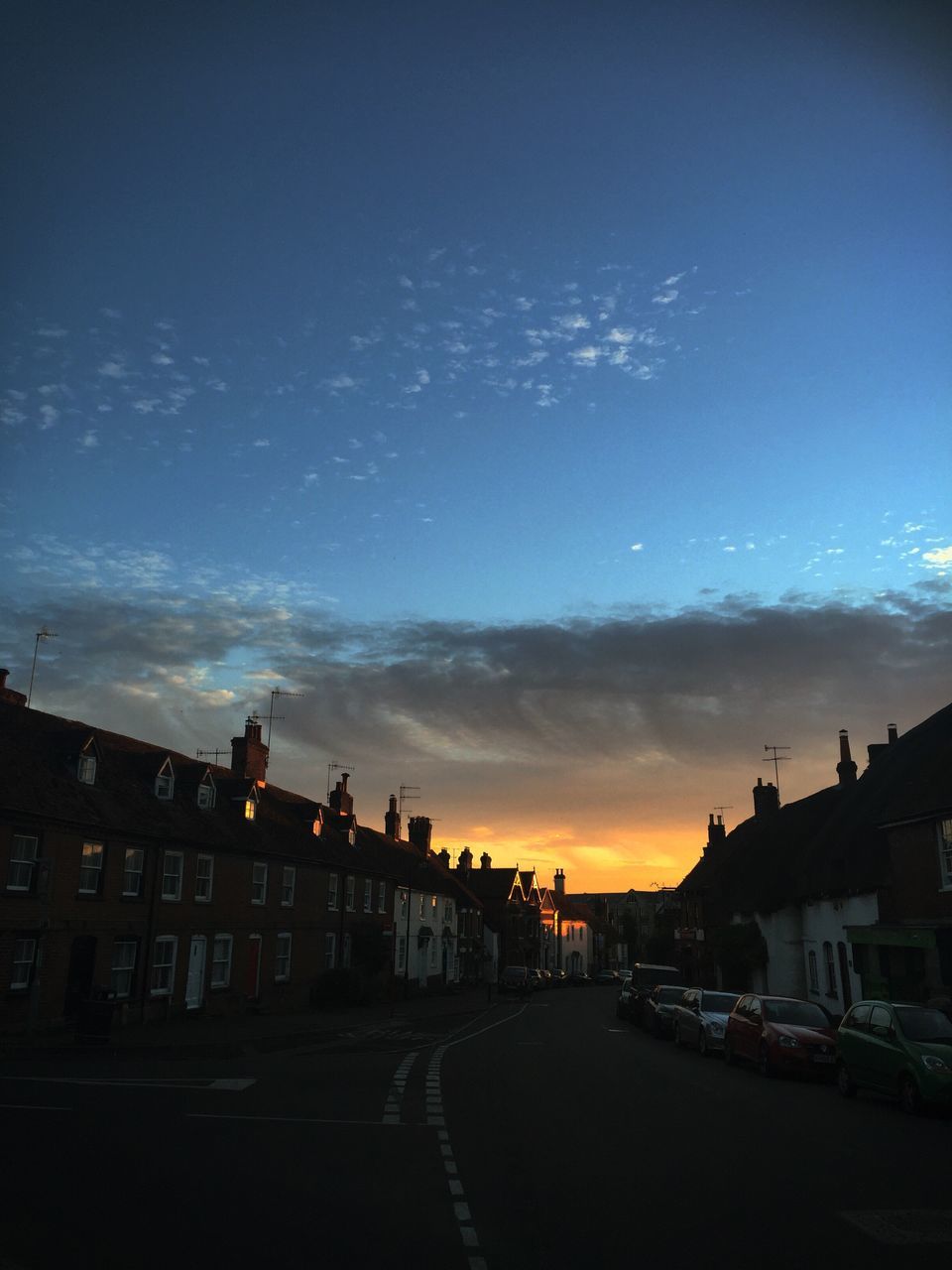 architecture, built structure, sunset, sky, road, city, outdoors, blue, cloud - sky, no people, the way forward, cloud, city life, illuminated, nature