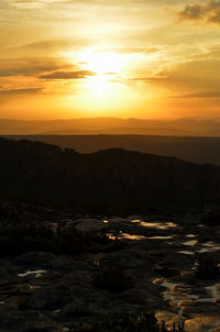 Scenic view of mountains against sky during sunset