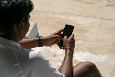 High angle view of man using mobile phone