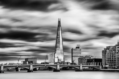 Thames river by shard against sky