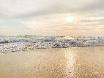 Scenic view of beach against sky during sunset