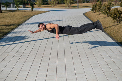 Low section of woman exercising on field