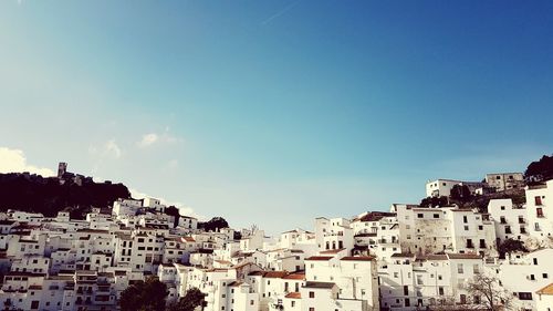 View of cityscape against blue sky