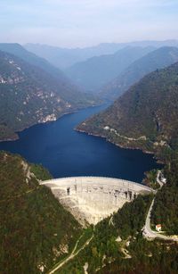 High angle view of river amidst mountains against sky