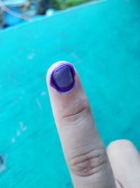 Close-up of human hand against blue background