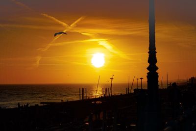 Scenic view of sea against orange sky