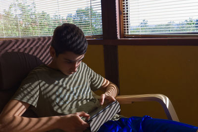 Young man sitting on seat