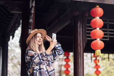 Portrait of young woman standing in city