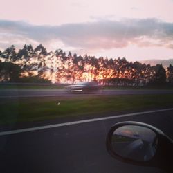 Cars on road at sunset