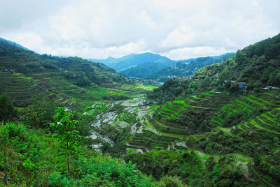 Scenic view of mountains against cloudy sky