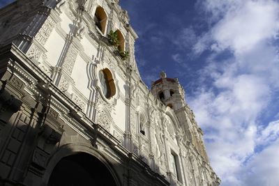 Low angle view of cathedral against cloudy sky