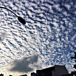 Low angle view of building against cloudy sky