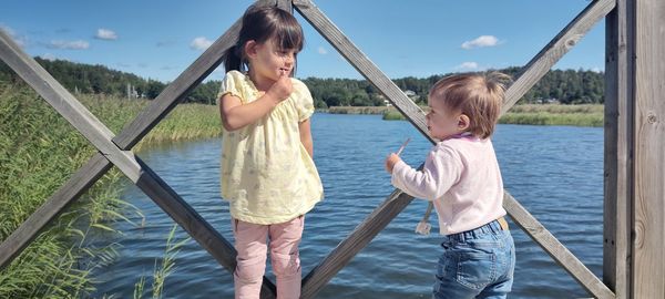 Women standing on riverbank