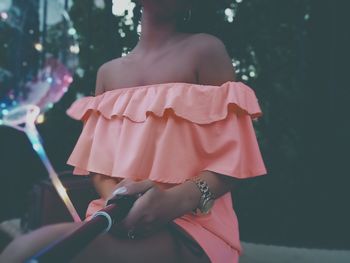 Rear view of woman with umbrella standing at music concert