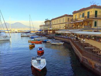 Boats in river with buildings in background