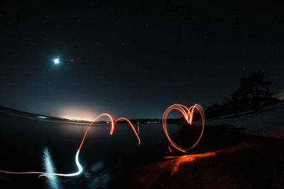 Light paintings at beach against during night