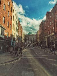 City street against cloudy sky