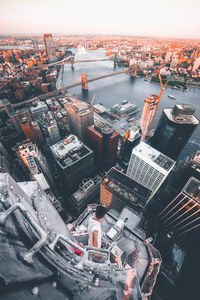 High angle view of city by river against sky