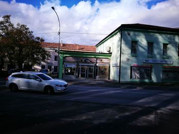 Cars on street against buildings in city