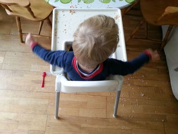 Rear view of boy sitting on chair