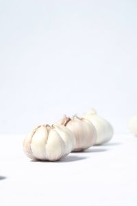 Close-up of bread on table against white background