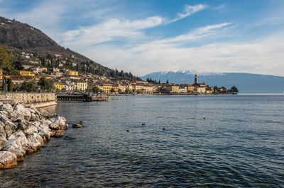 The beautiful lakeside of salò with the lake garda and the monte baldo in background