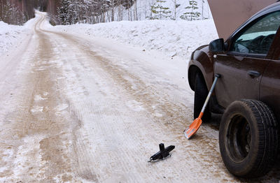 Low section of man skiing on snow covered road