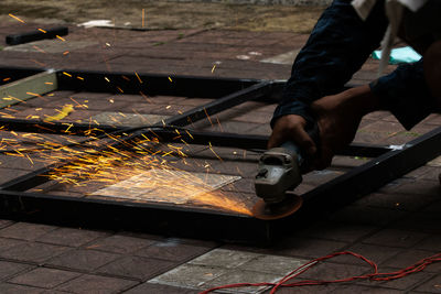 Cropped hand of worker working at factory