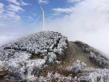 Low angle view of snow covered mountain against sky