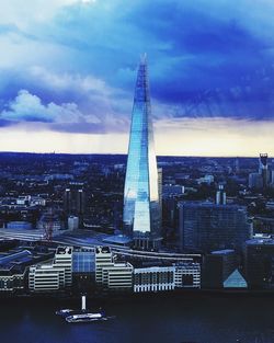 Aerial view of city against cloudy sky