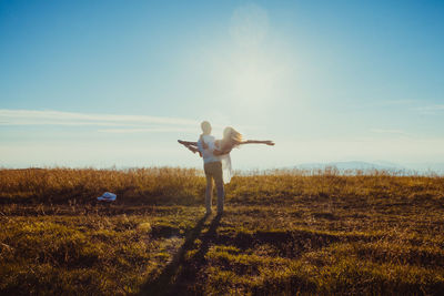 Full length of man standing on field against sky