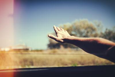 Midsection of person against sky seen through window