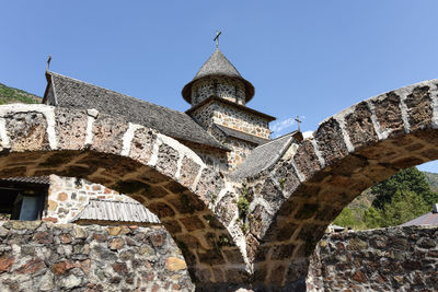 Low angle view of old building against clear blue sky