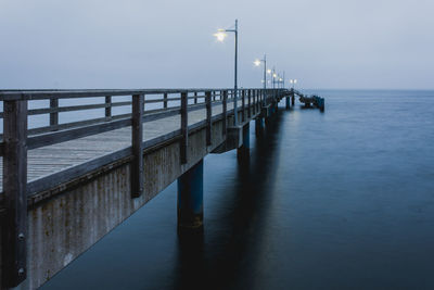 Pier over sea against sky