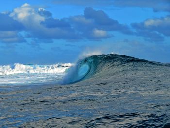 Scenic view of sea waves against sky