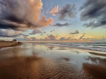 Scenic view of beach against sky during sunset