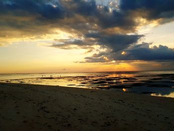 Scenic view of beach against sky during sunset