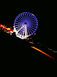 Low angle view of ferris wheel against sky at night