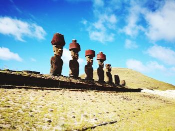 Low angle view of people on land against sky
