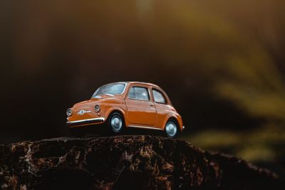 Close-up of toy car on rock