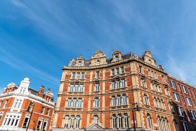 Low angle view of buildings against blue sky