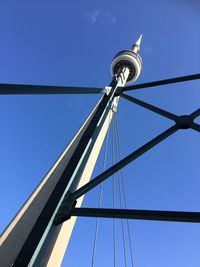 Low angle view of communications tower against blue sky