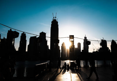 Silhouette of buildings against sky during sunset