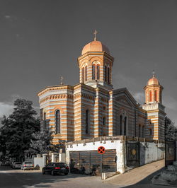 Cathedral and buildings in city against sky