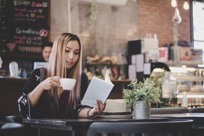 Woman drinking coffee in cafe