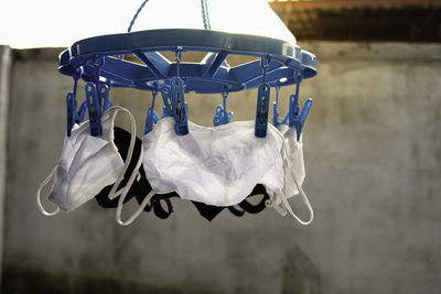 Drying mask hanging under the sun after use for disinfecting. cotton cloth mask hanging outdoor.