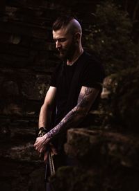 Man with tattoo standing outdoors